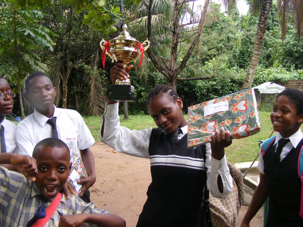 Royal Regency pupils raising their hands during morning assembly